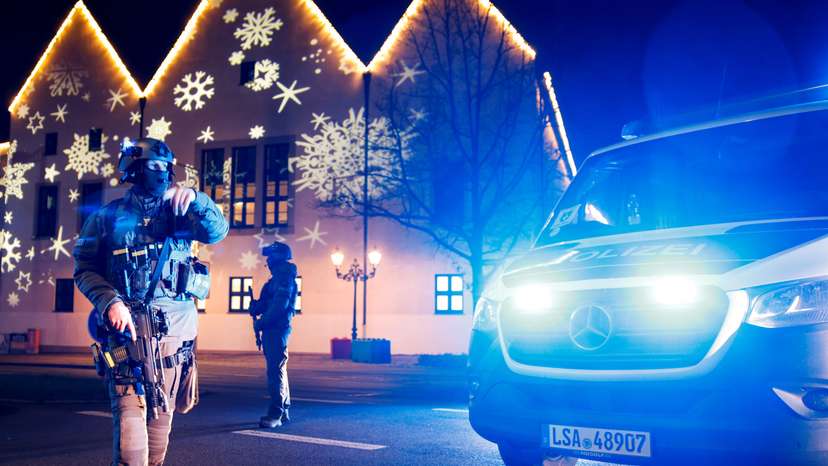 Members of police work at a Christmas market after a car drove into a group of people, in Magdeburg