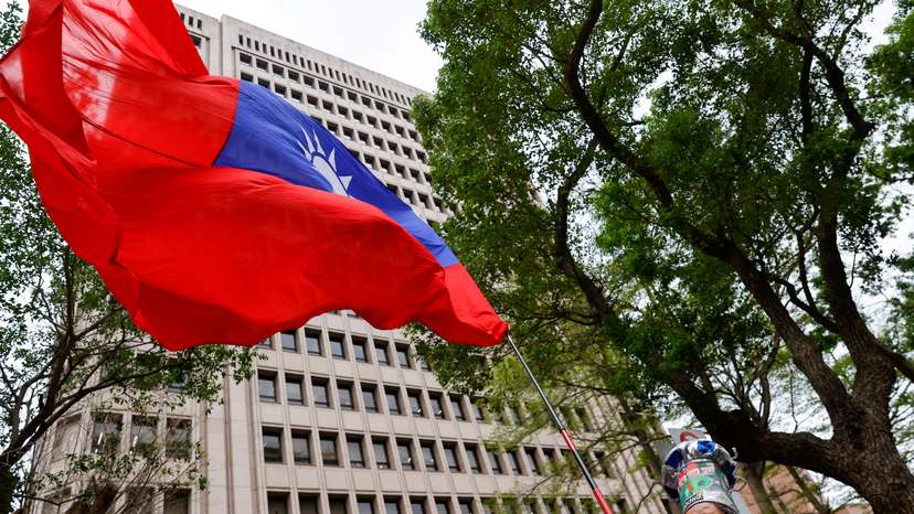 FILE PHOTO: A supporter of the main opposition party Kuomintang (KMT) waves a Taiwanese flag outside of the Central Election Commission, in Taipei