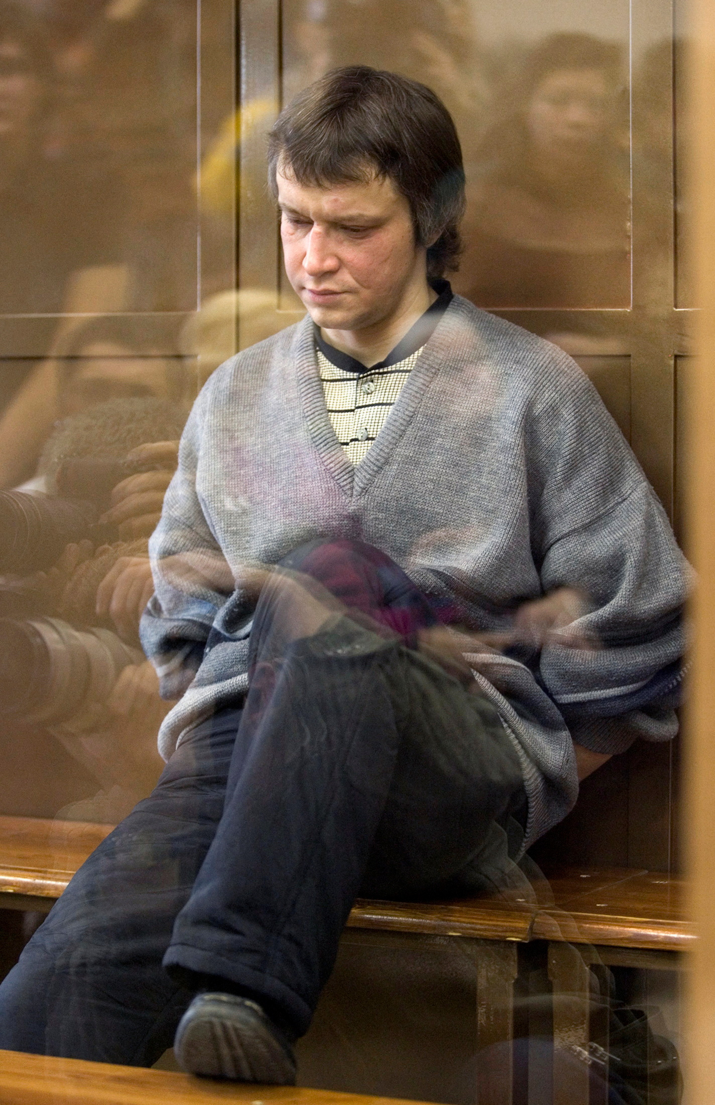 FILE PHOTO: Alexander Pichushkin sits behind the glass in a Moscow court