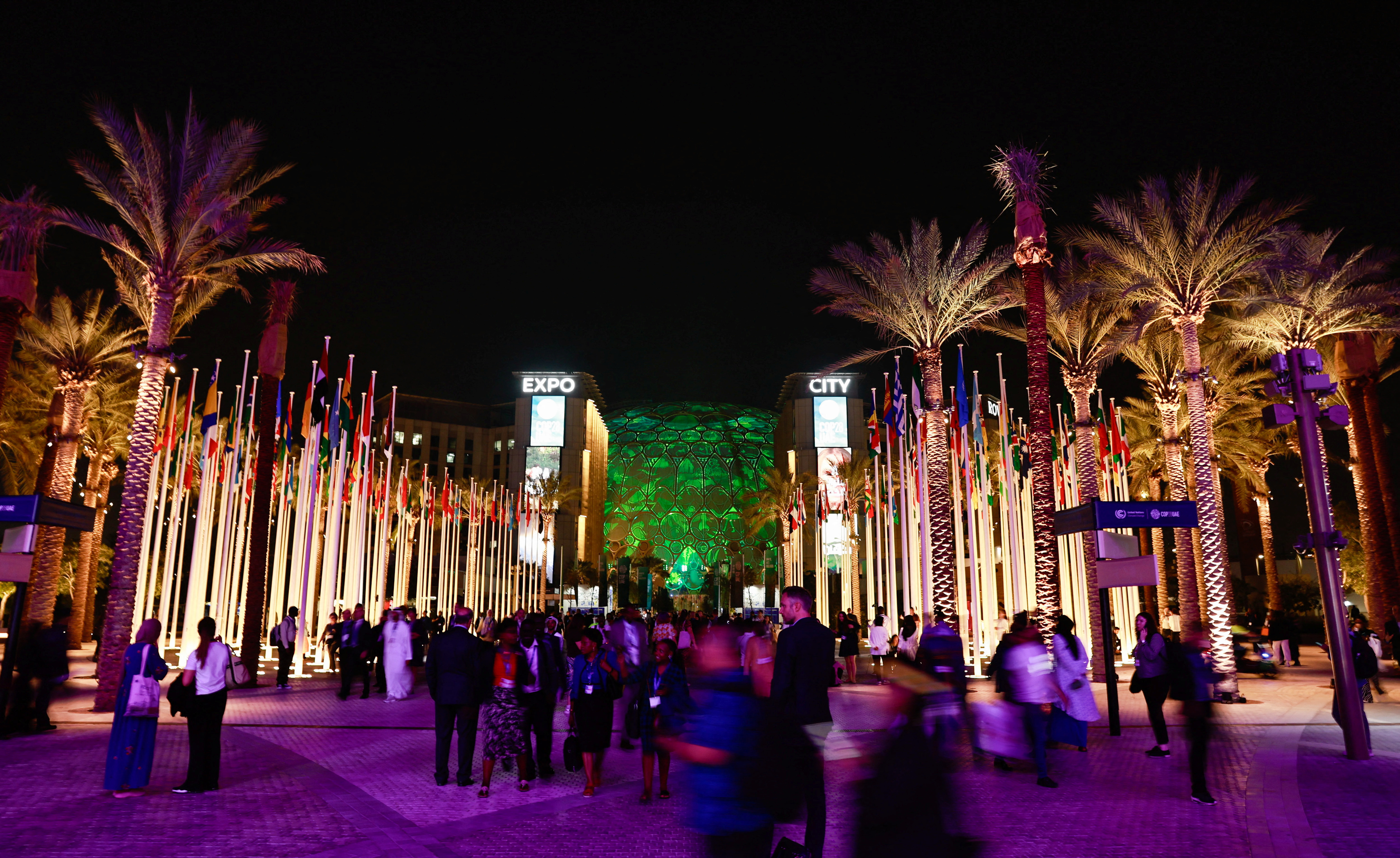 Delegates walk at Dubai's Expo City during the United Nations Climate Change Conference (COP28), in Dubai