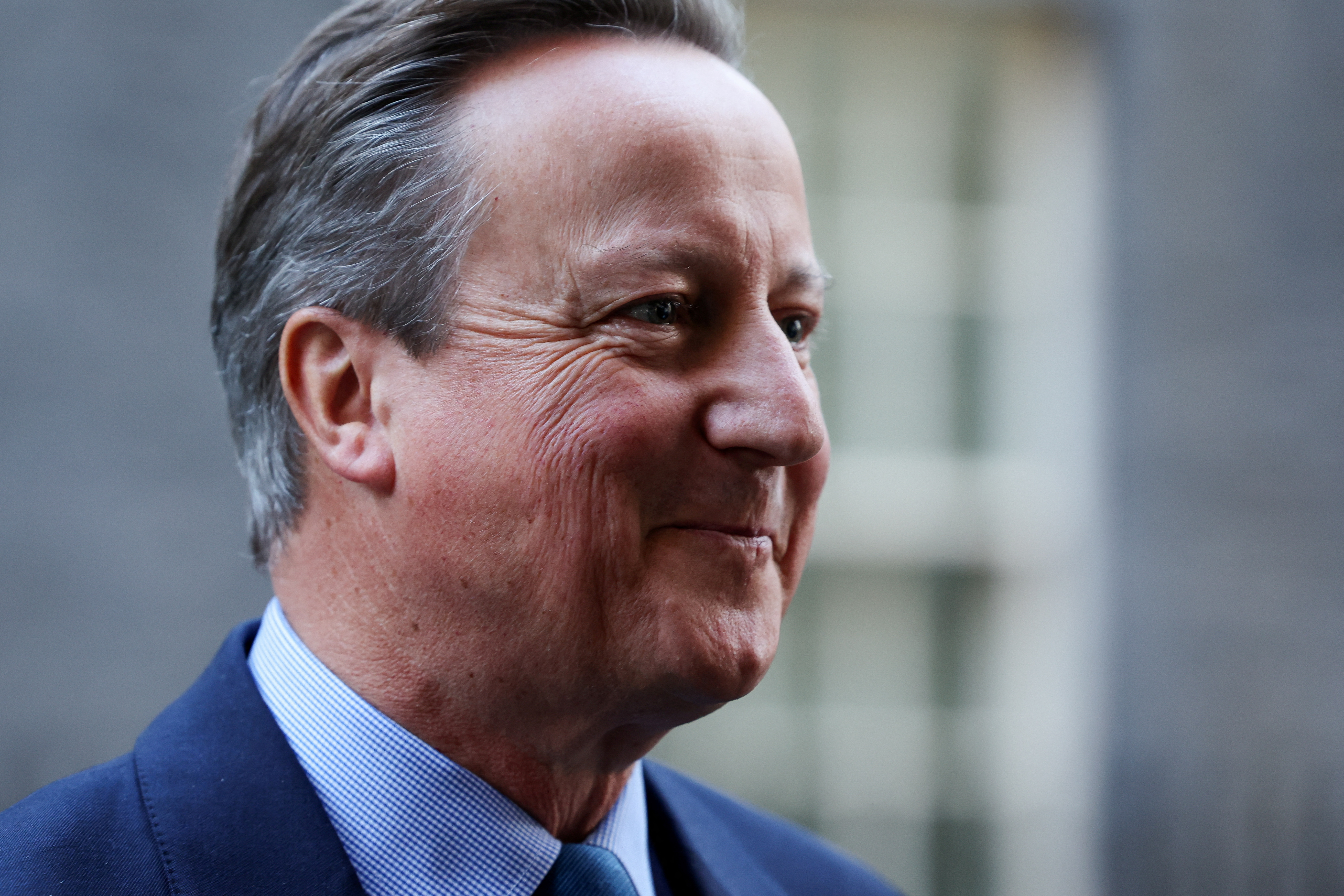 Britain's former Prime Minister and newly appointed Foreign Secretary David Cameron reacts outside 10 Downing Street in London