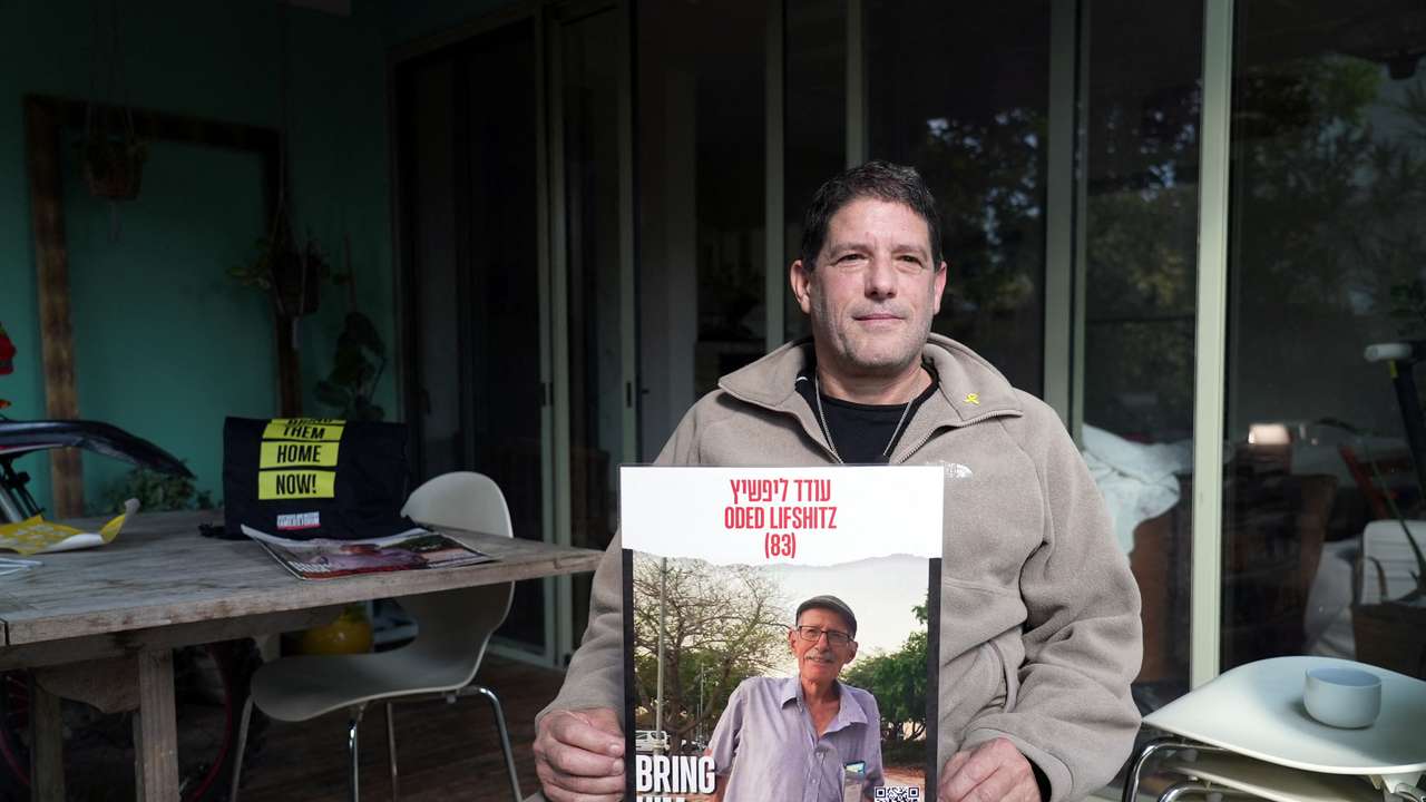 Yzhar Lifshitz, a resident of Kibbutz Nir Oz, holds a poster of his father, Oded Lifshitz, 84, who has been held hostage in Gaza since the deadly October 7, 2023 attack by Hamas, during an interview with Reuters in Karmei Yosef