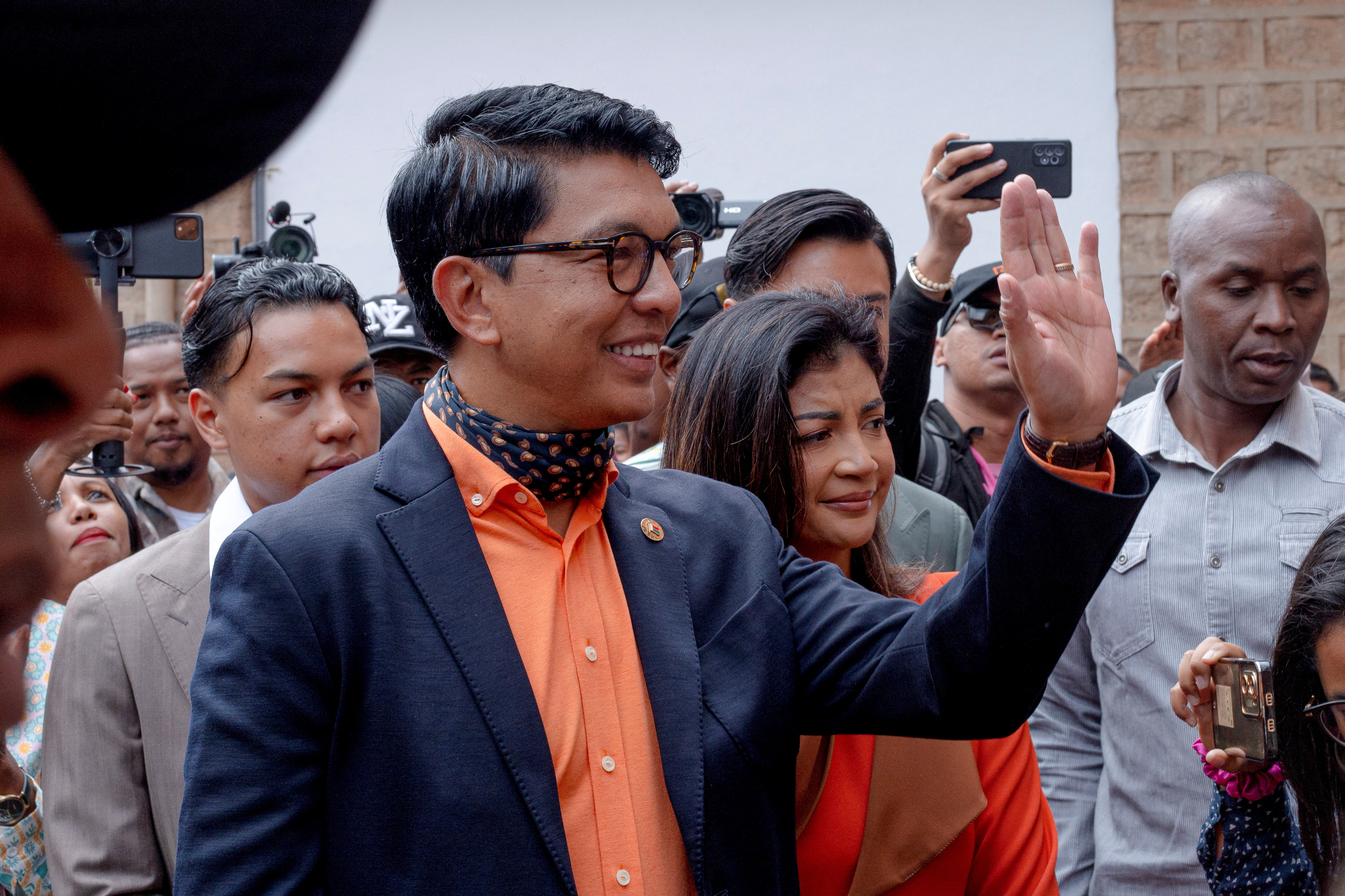Madagascar's President and a presidential candidate Andry Rajoelina flanked by his wife Mialy Rajoelina as he arrives to cast his ballot at a polling station, during the presidential election in Ambatobe