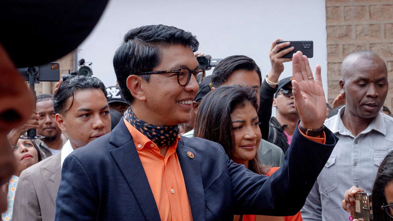 Madagascar's President and a presidential candidate Andry Rajoelina flanked by his wife Mialy Rajoelina as he arrives to cast his ballot at a polling station, during the presidential election in Ambatobe