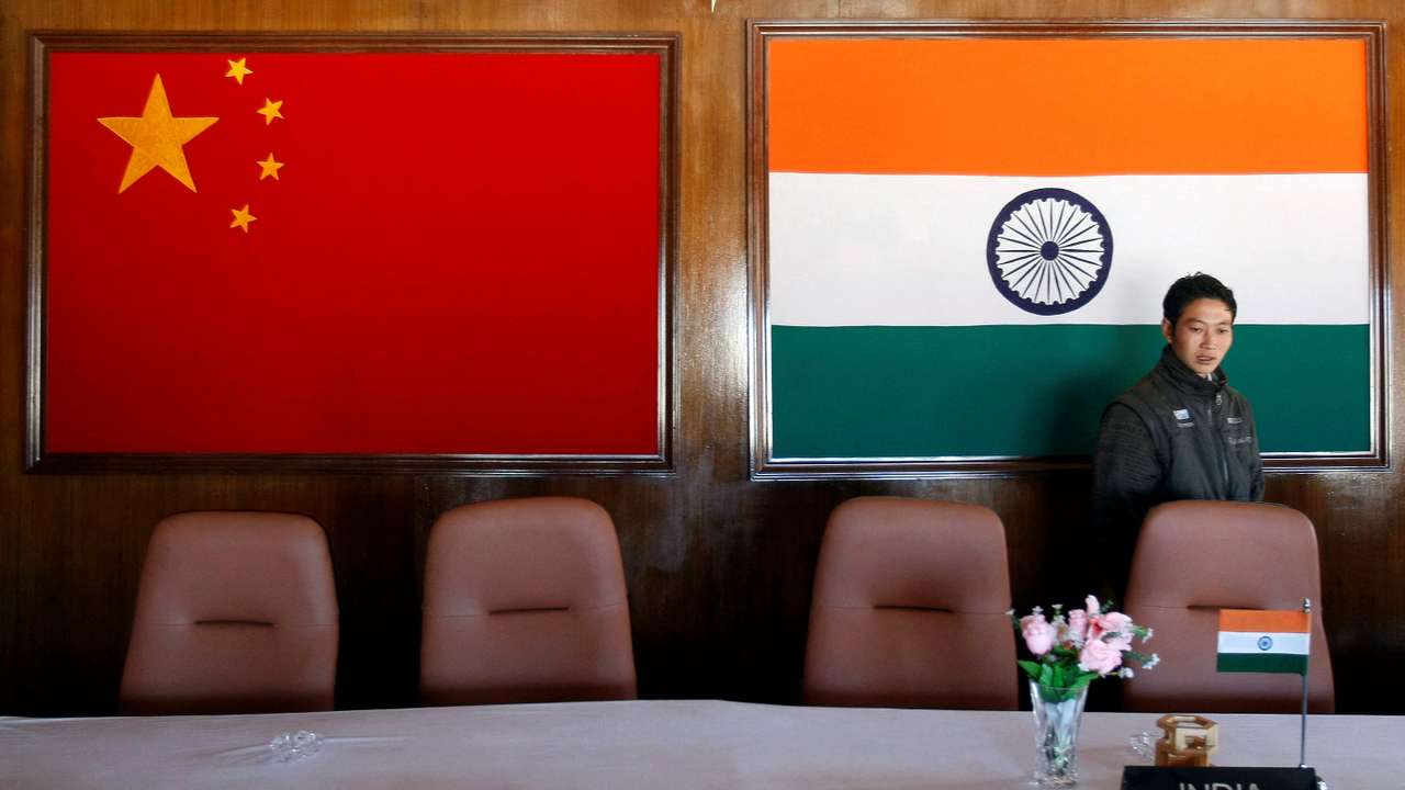 A man walks inside a conference room used for meetings between military commanders of China and India, at the Indian side of the Indo-China border at Bumla