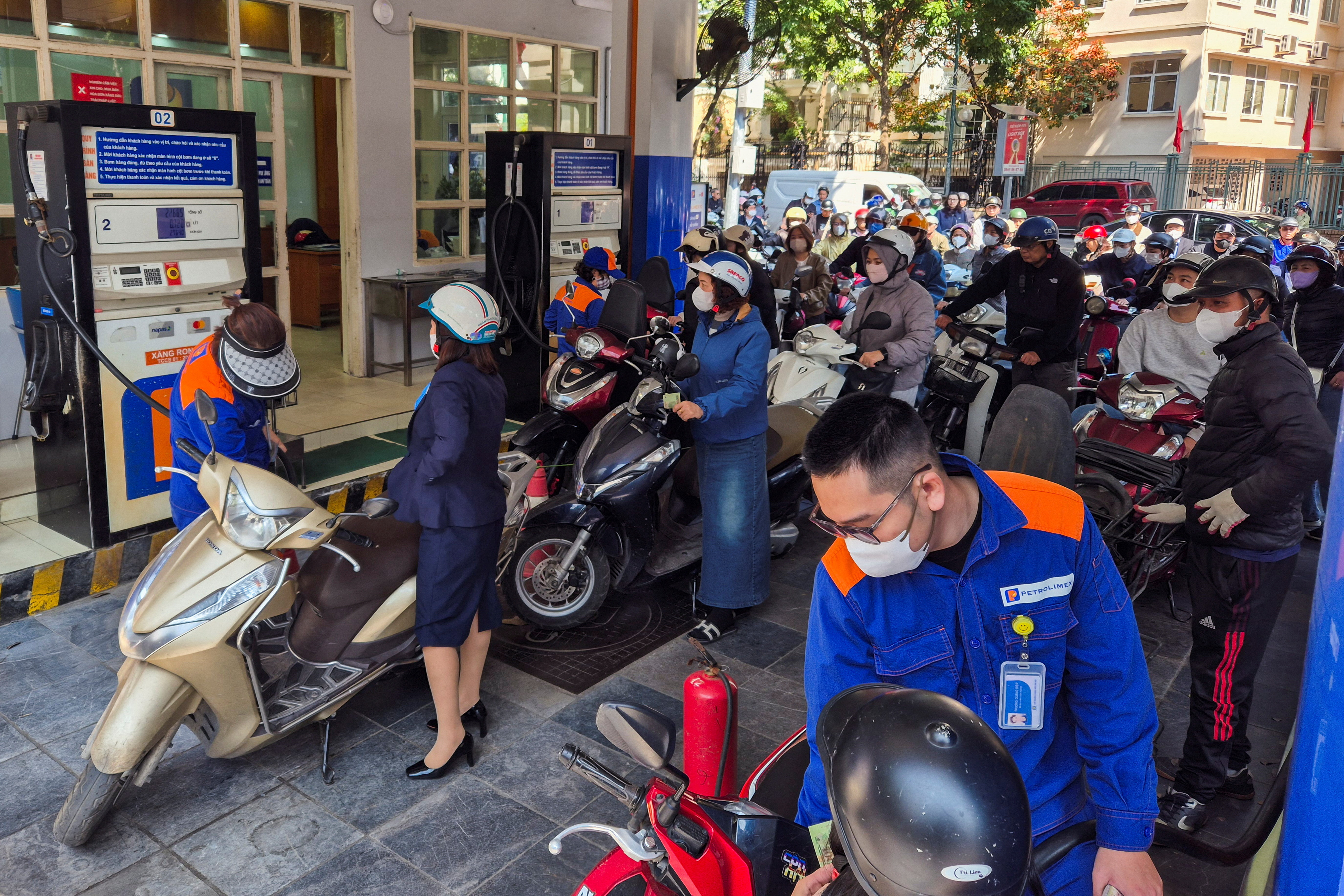 People queue to buy petrol at a petrol station after Vietnam's trade ministry called on local businesses to encourage their employees to work from home, amid the U.S.-Israeli conflict with Iran, in Hanoi