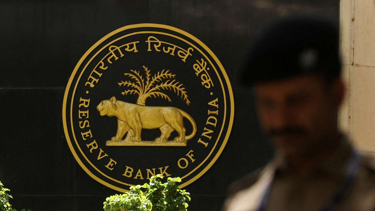 FILE PHOTO: FILE PHOTO: A police officer walks past the Reserve Bank of India (RBI) logo inside its headquarters in Mumbai