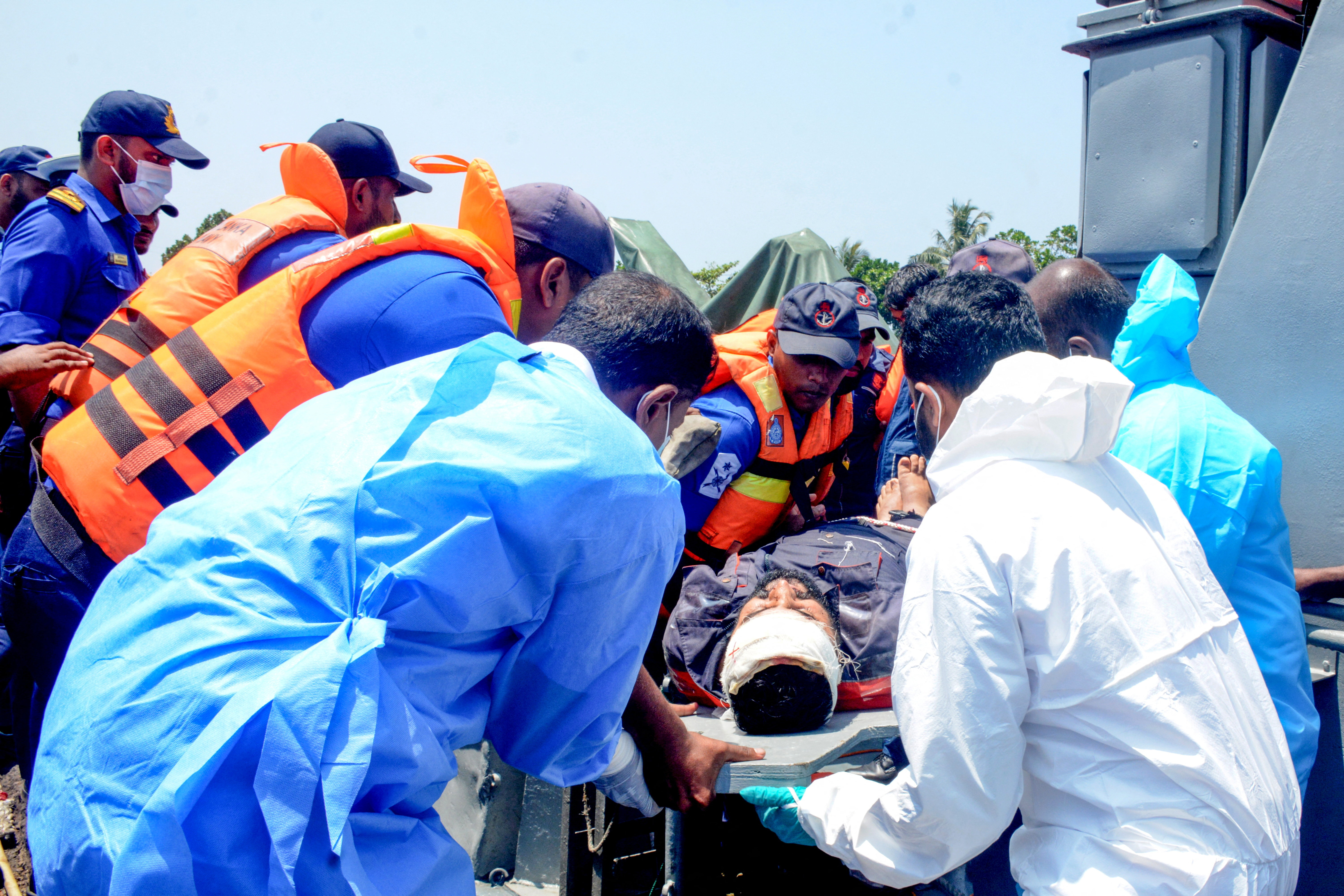 Sri Lanka Navy personnel assist Iranian sailors during a rescue operation in Indian Ocean
