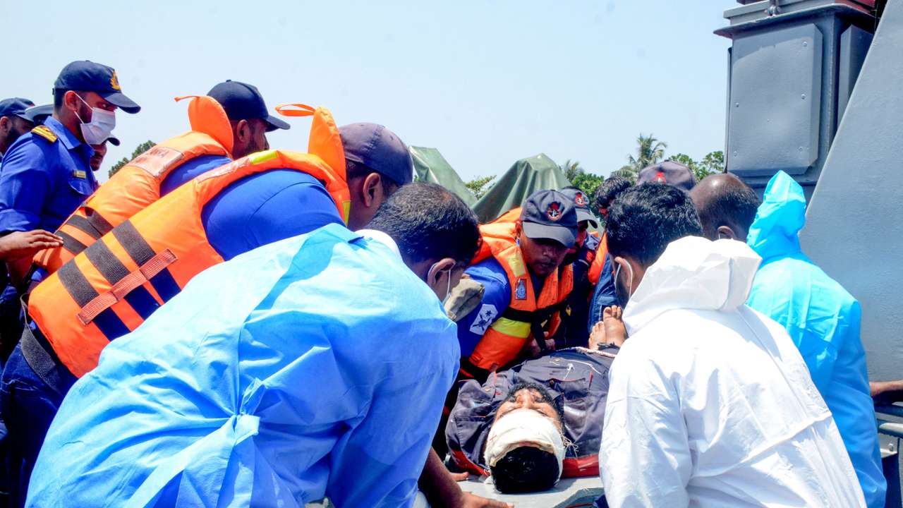 Sri Lanka Navy personnel assist Iranian sailors during a rescue operation in Indian Ocean