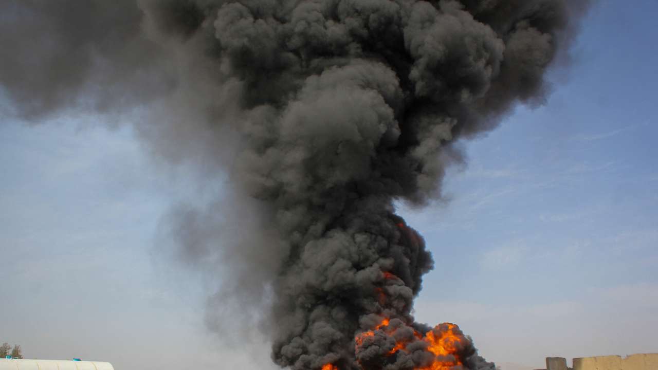Thick black smoke rises at private airline Kam Air's fuel depot after a strike in what the Taliban said was a Pakistani air strike, in Kandahar