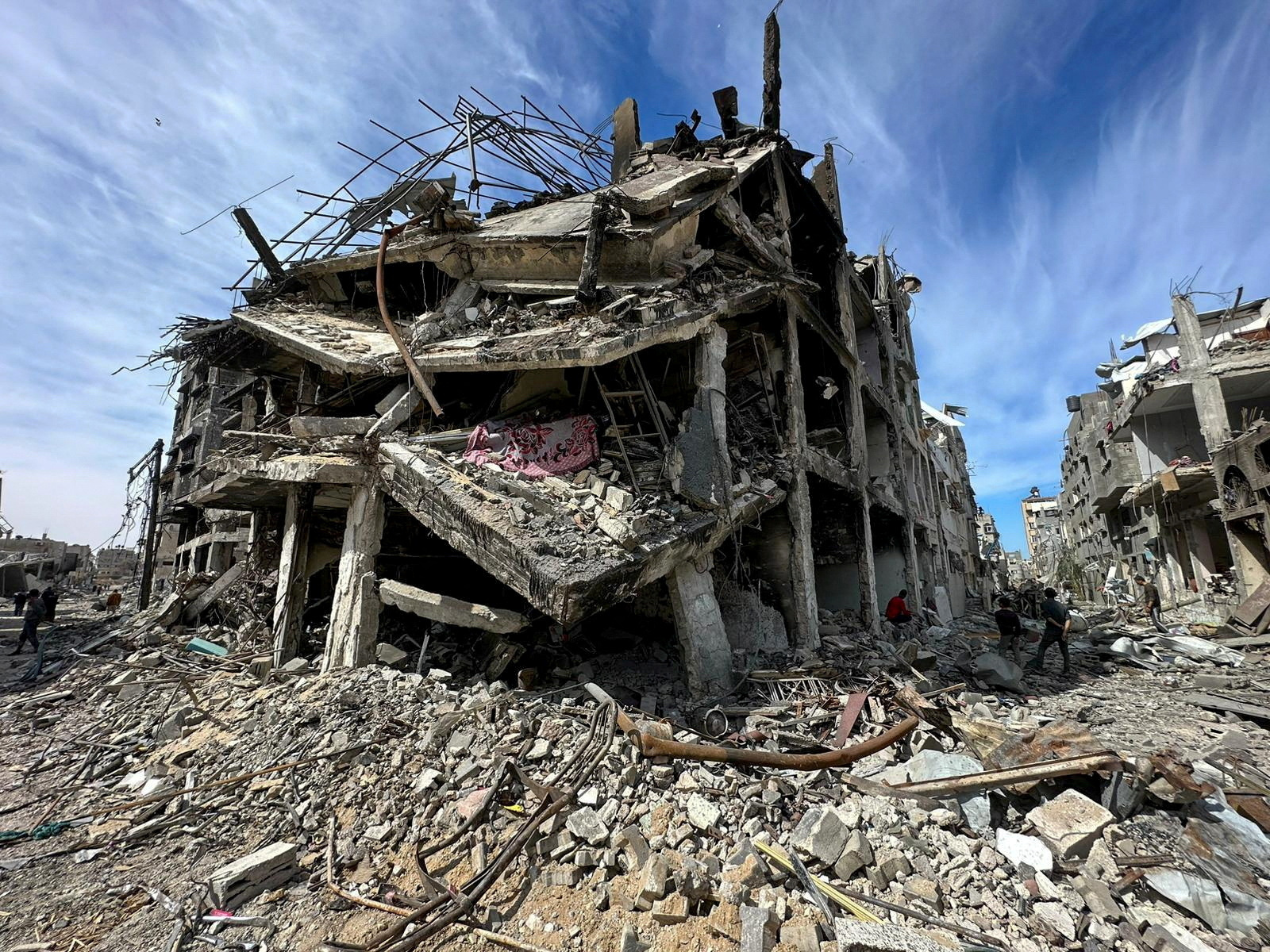 FILE PHOTO: Residents inspect damages caused to Zeitoun neighborhood, in Gaza City