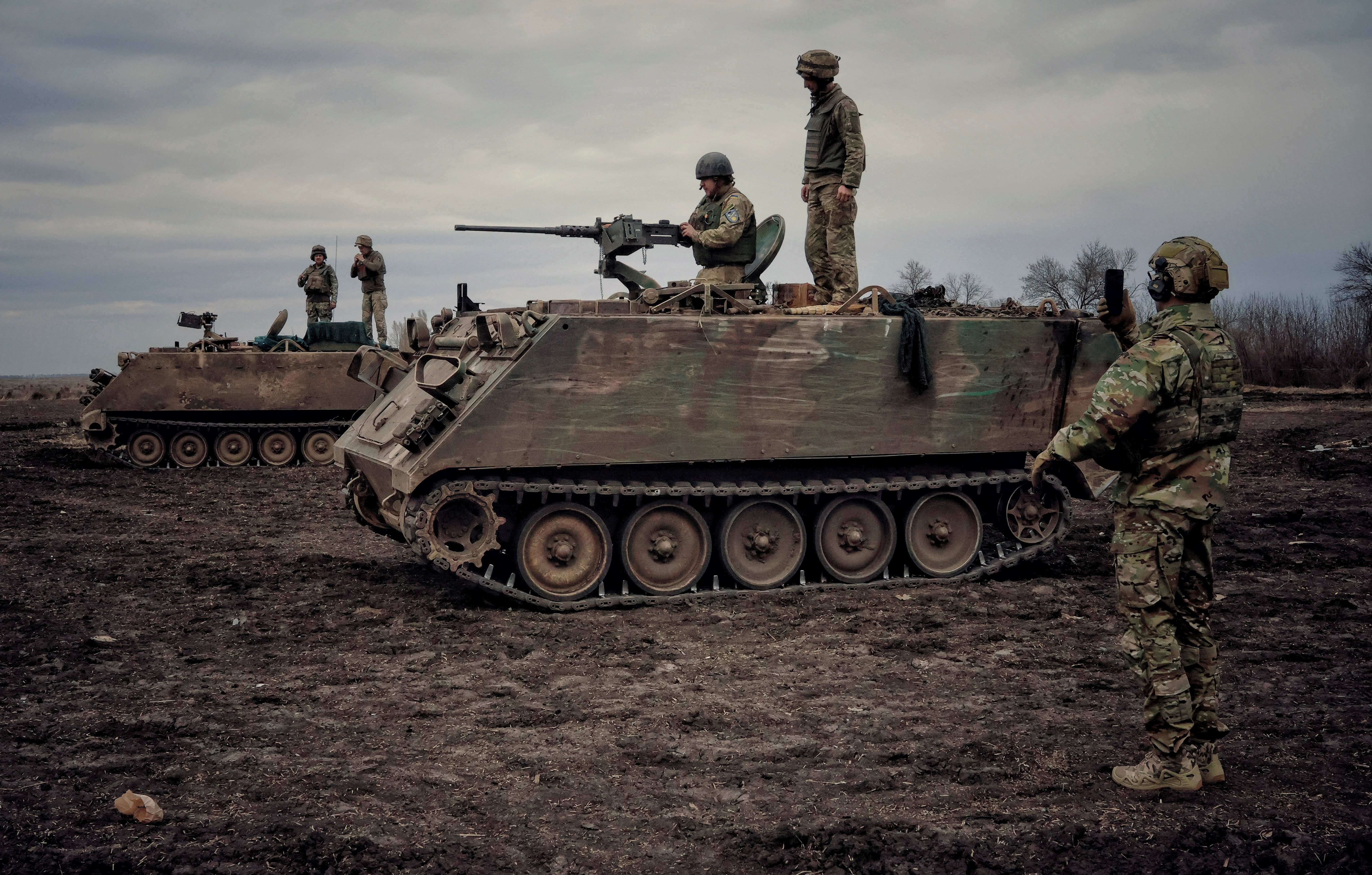 Ukrainian servicemen train to shoot a machine gun from M113 Armoured Personnel Carrier during a training session in Donbas region
