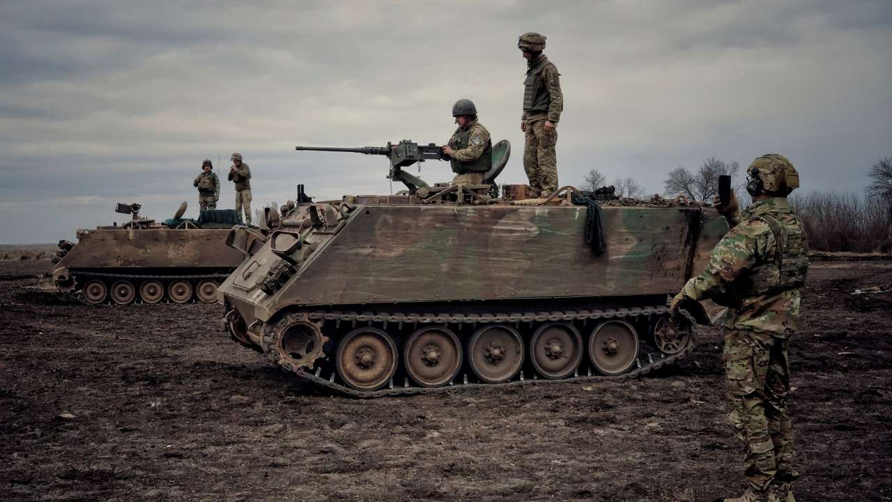 Ukrainian servicemen train to shoot a machine gun from M113 Armoured Personnel Carrier during a training session in Donbas region
