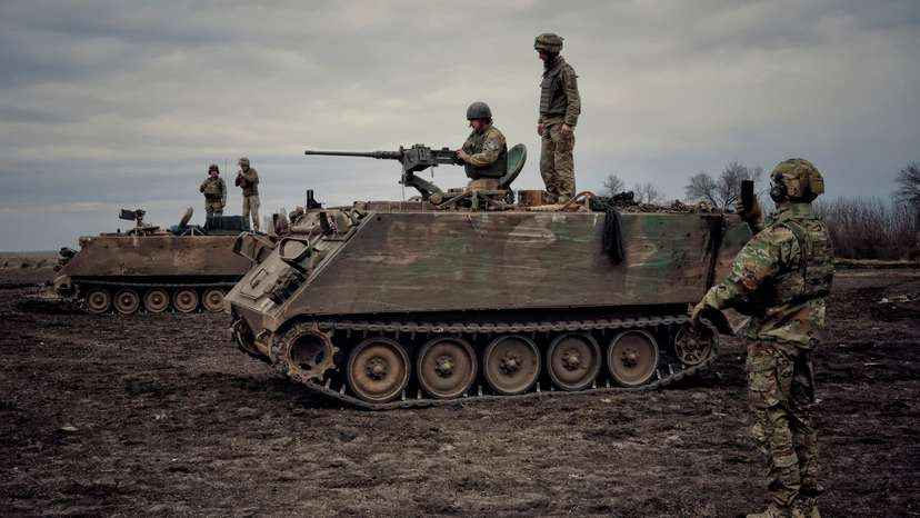 Ukrainian servicemen train to shoot a machine gun from M113 Armoured Personnel Carrier during a training session in Donbas region