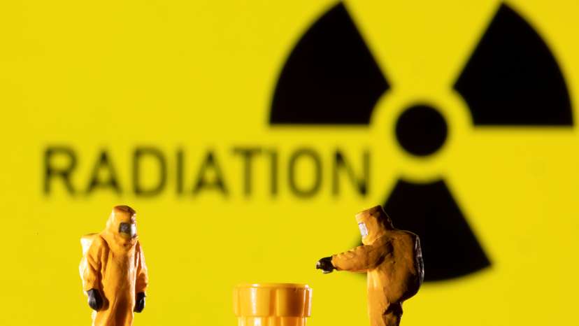 Illustration shows figurines in protective equipments and a Radiation sign