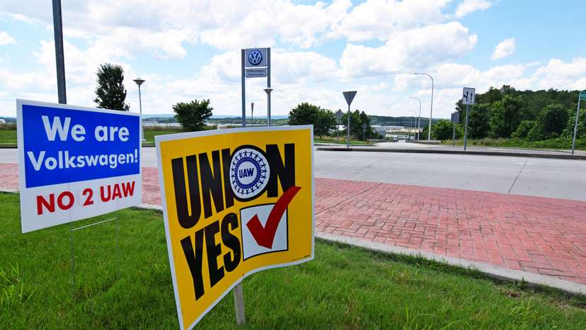 FILE PHOTO: Signs stand outside a Volkswagen plant during a vote among local workers over whether or not to be represented by the United Auto Workers union in Chattanooga,