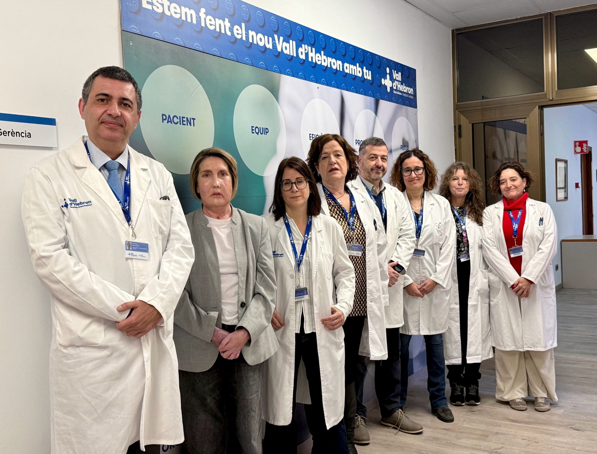 Carme, recipient of the world's first face transplant, poses for a photo with the Vall d'Hebron Hospital surgery team, in Barcelona