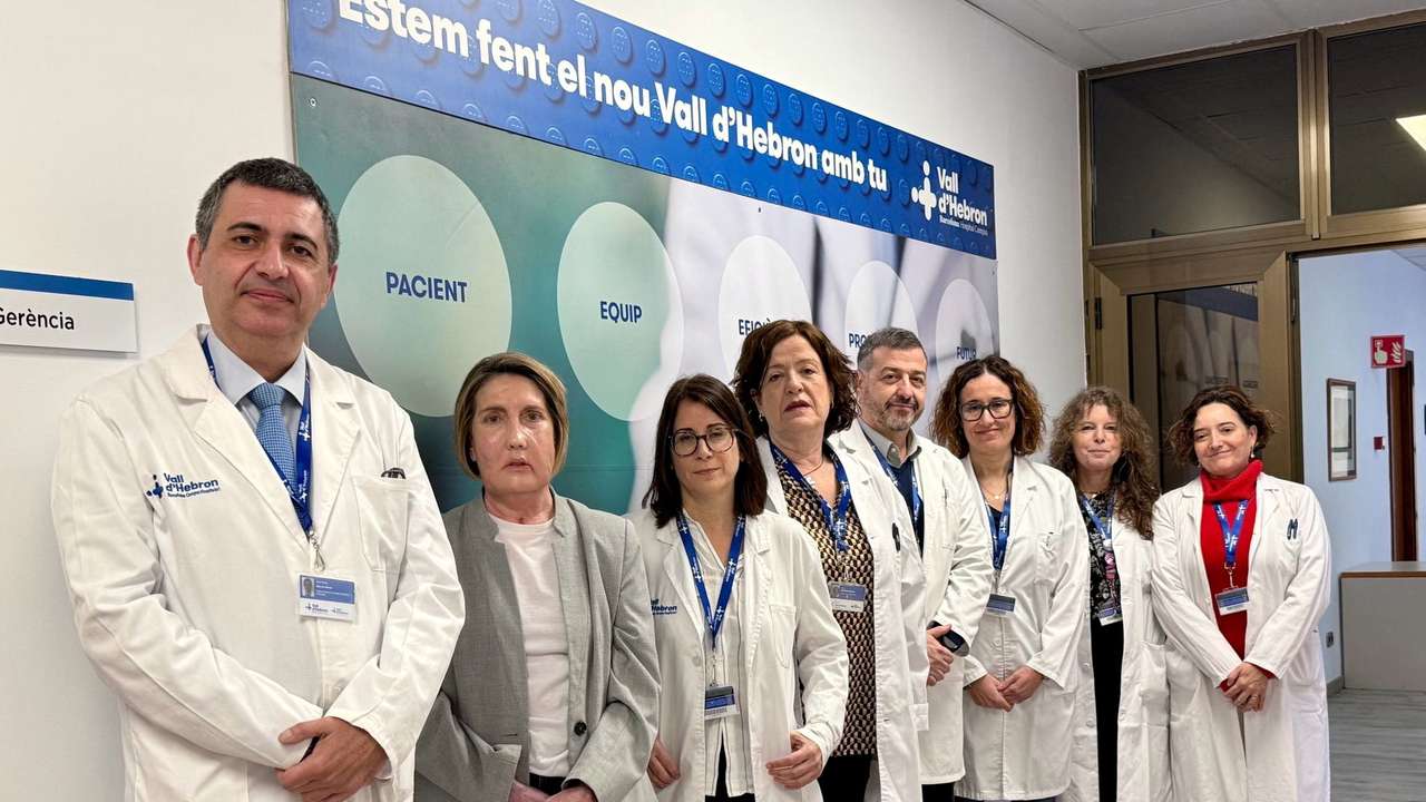 Carme, recipient of the world's first face transplant, poses for a photo with the Vall d'Hebron Hospital surgery team, in Barcelona