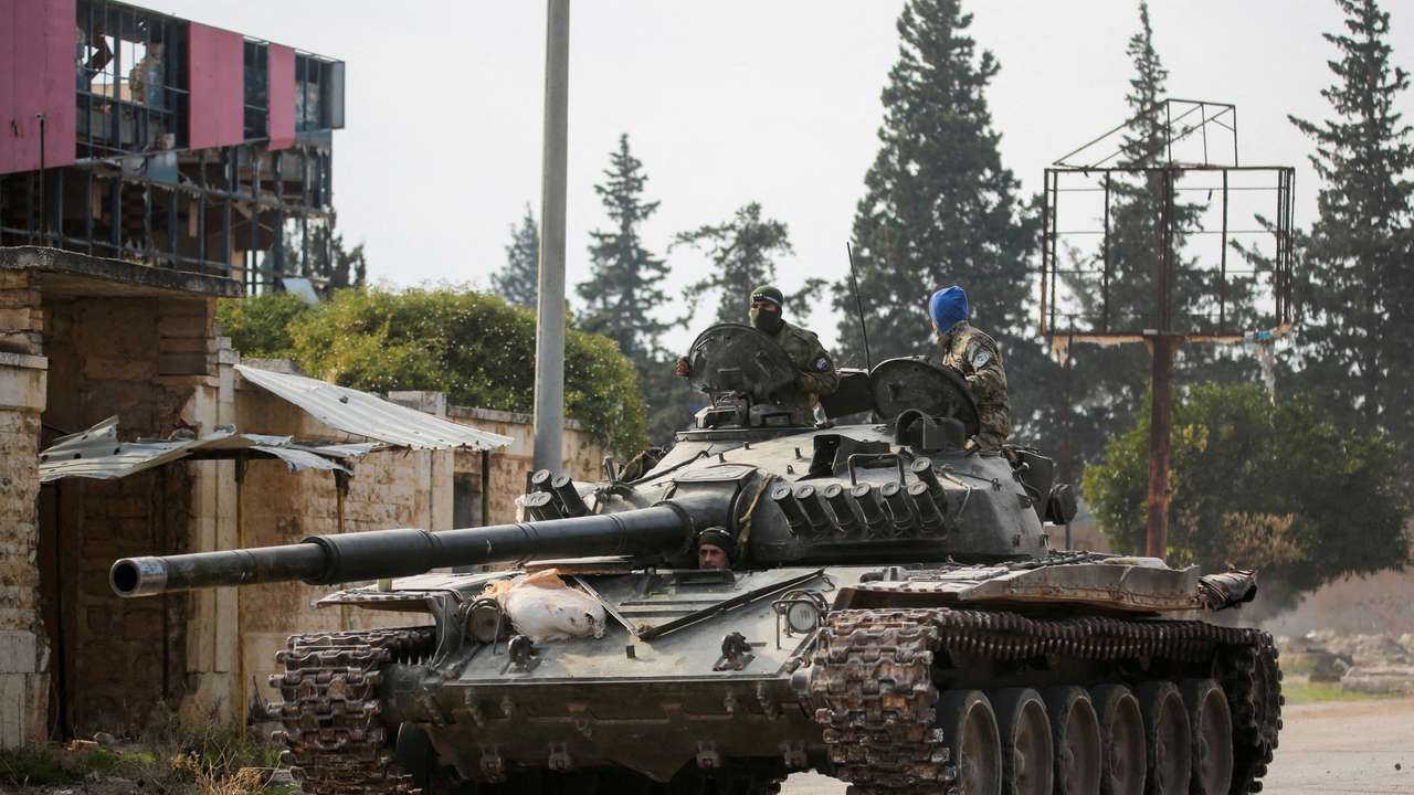 FILE PHOTO: Rebels led by the Islamist militant group Hayat Tahrir al-Sham drive a military vehicle in al-Rashideen