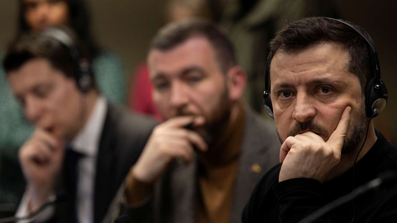 Ukrainian President Volodymyr Zelenskiy listens during a meeting with members of the media on the outskirts of London