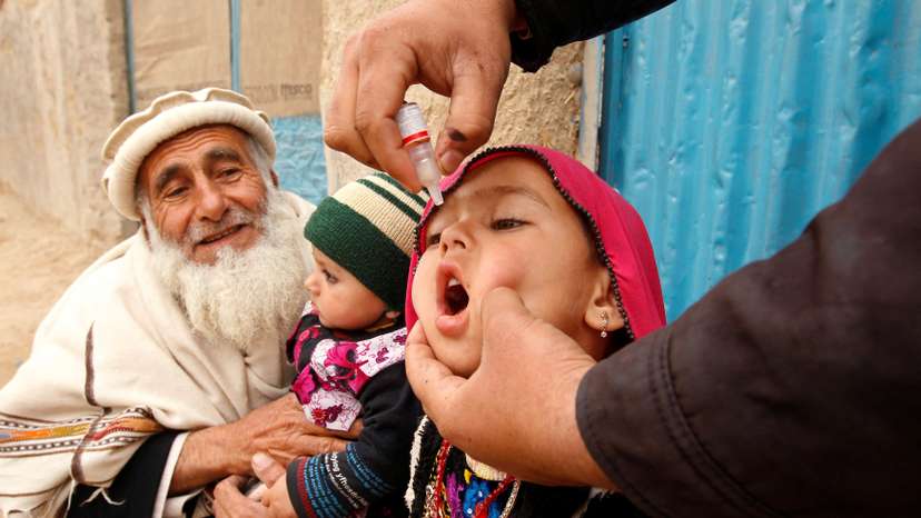 FILE PHOTO: A child receives a polio vaccination during an anti-polio campaign on the outskirts of Jalalabad