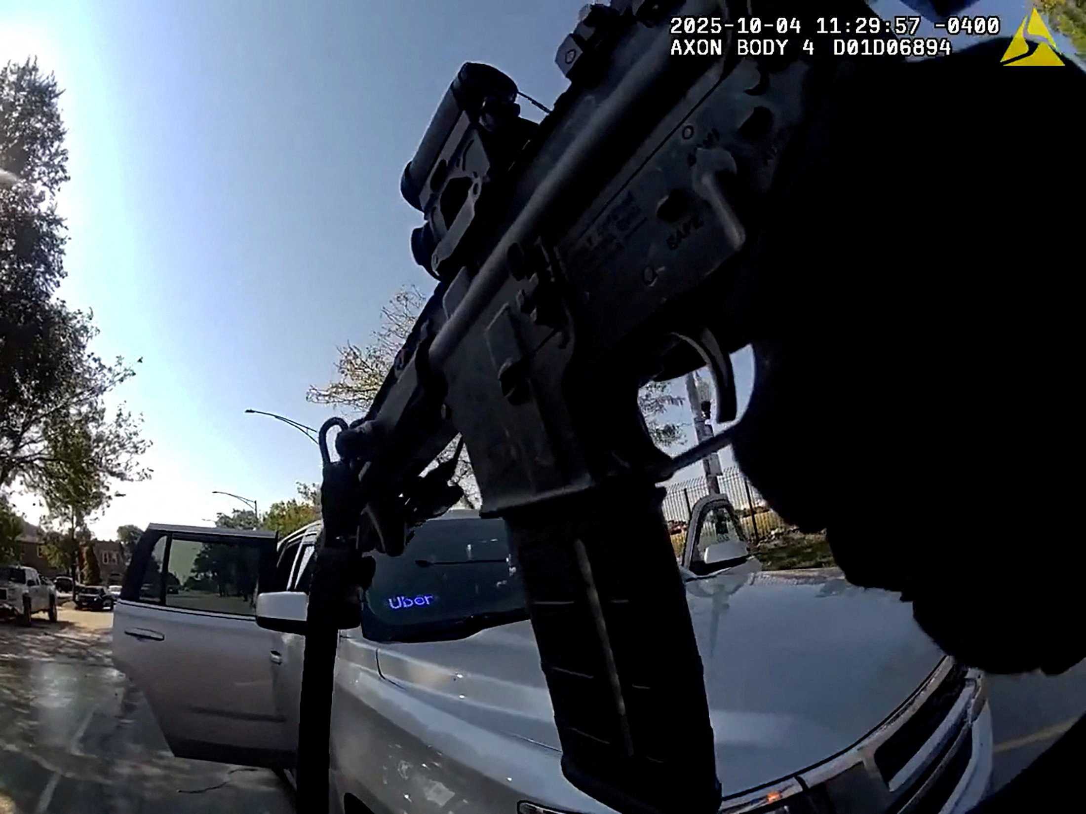 U.S. Border Patrol officer hold his weapon after a collision in Chicago