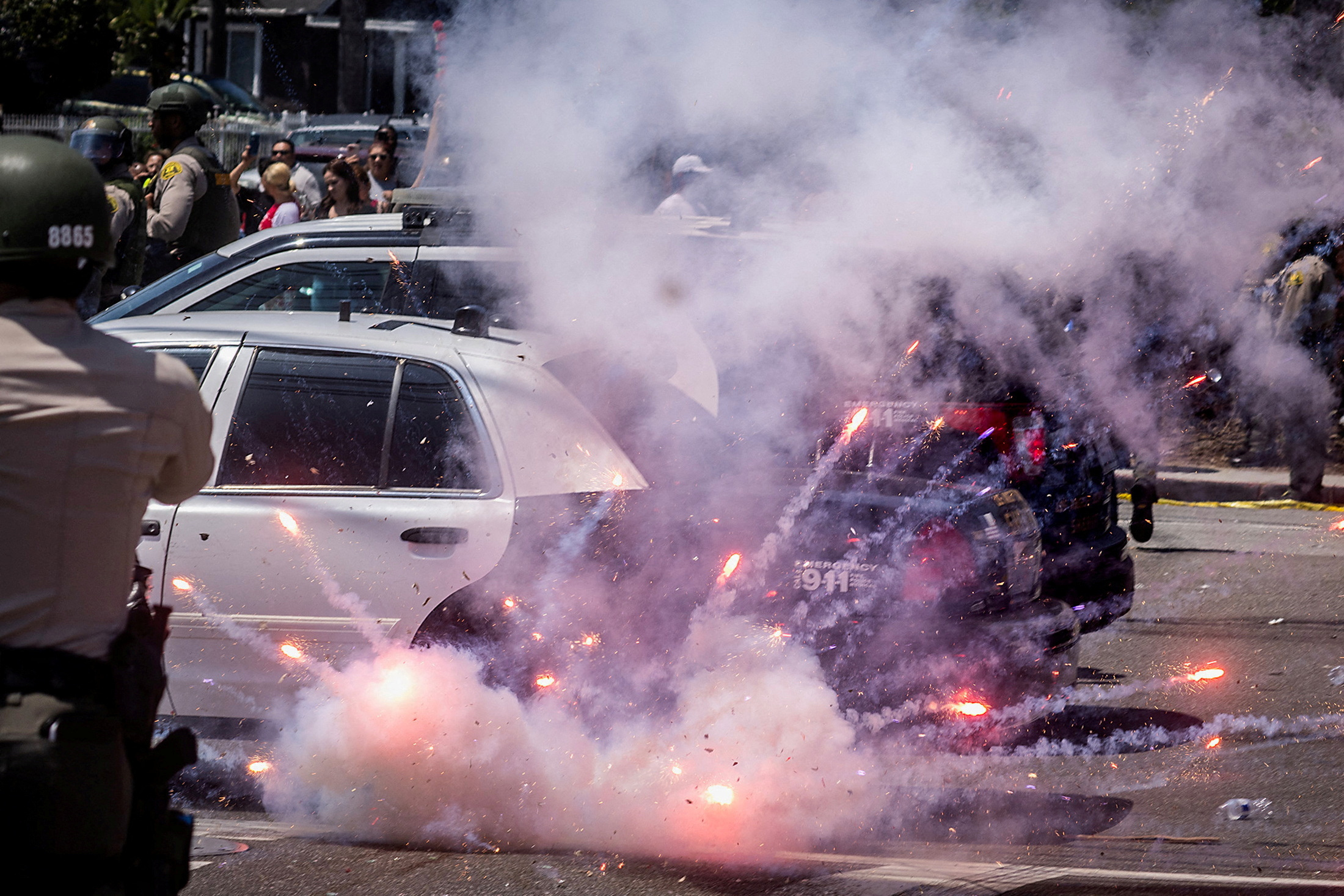 A firework explodes after being thrown at police during a standoff with protesters in Paramount