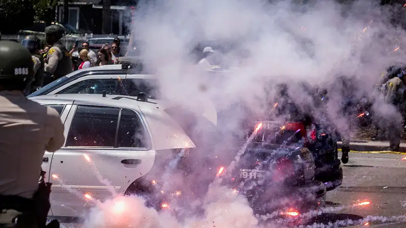 A firework explodes after being thrown at police during a standoff with protesters in Paramount