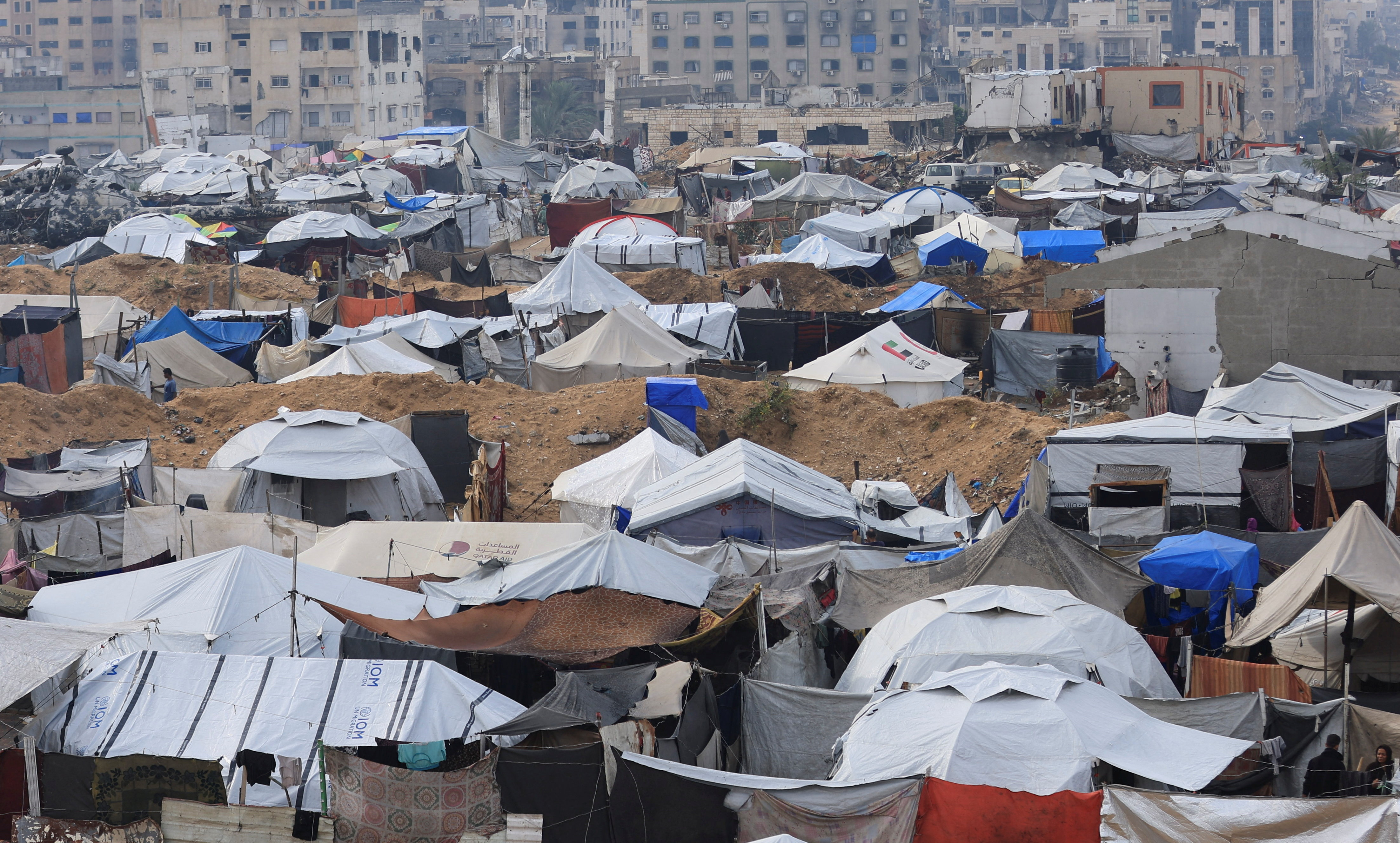 Palestinians shelter in tents during rain in Gaza City