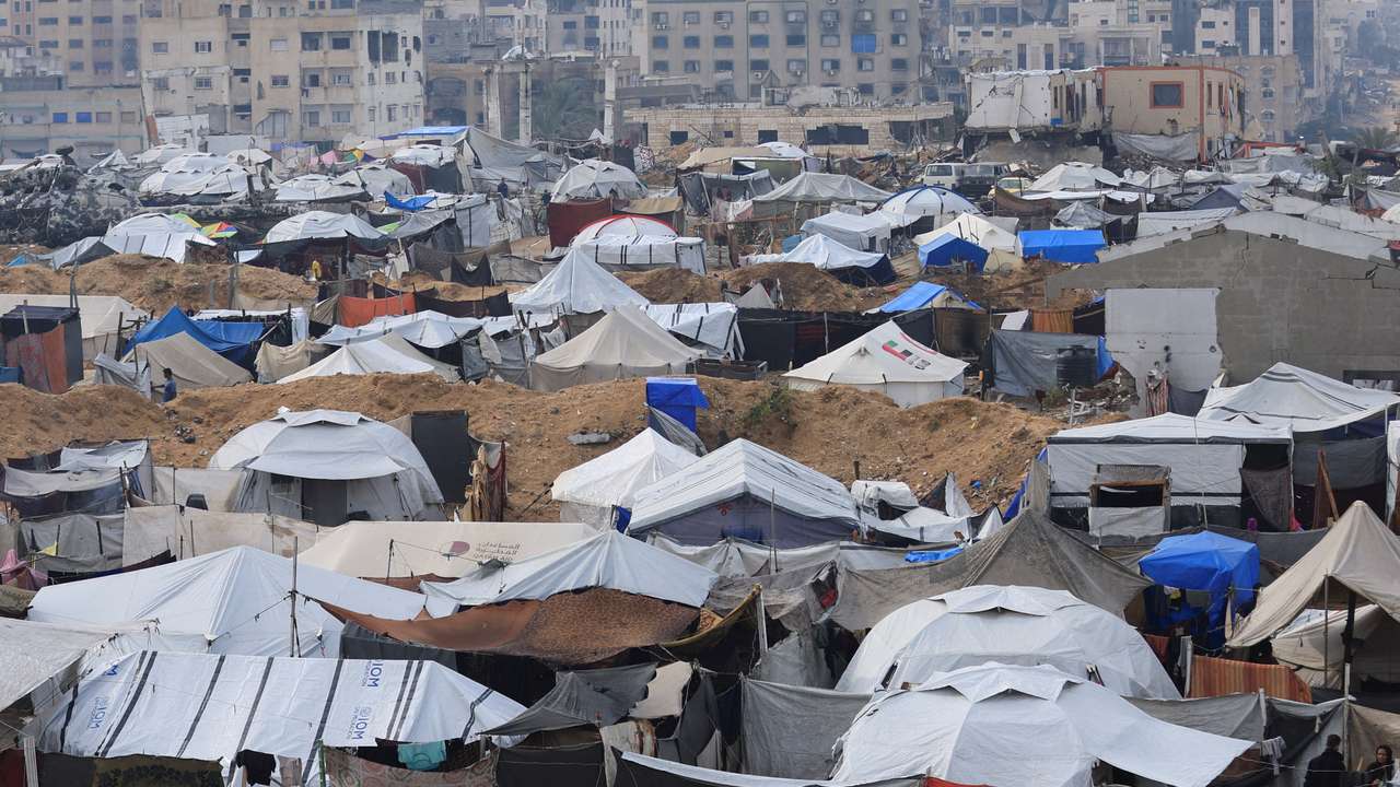 Palestinians shelter in tents during rain in Gaza City