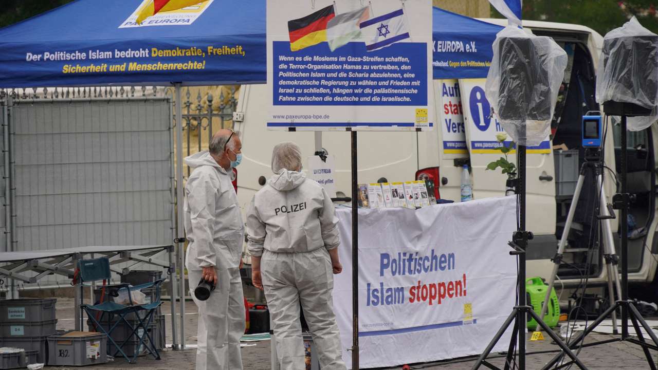 FILE PHOTO: Police investigators work at the scene where a man attacked people at a far right-wing information stand of the Buergerbewegung Pax Europa in Mannheim
