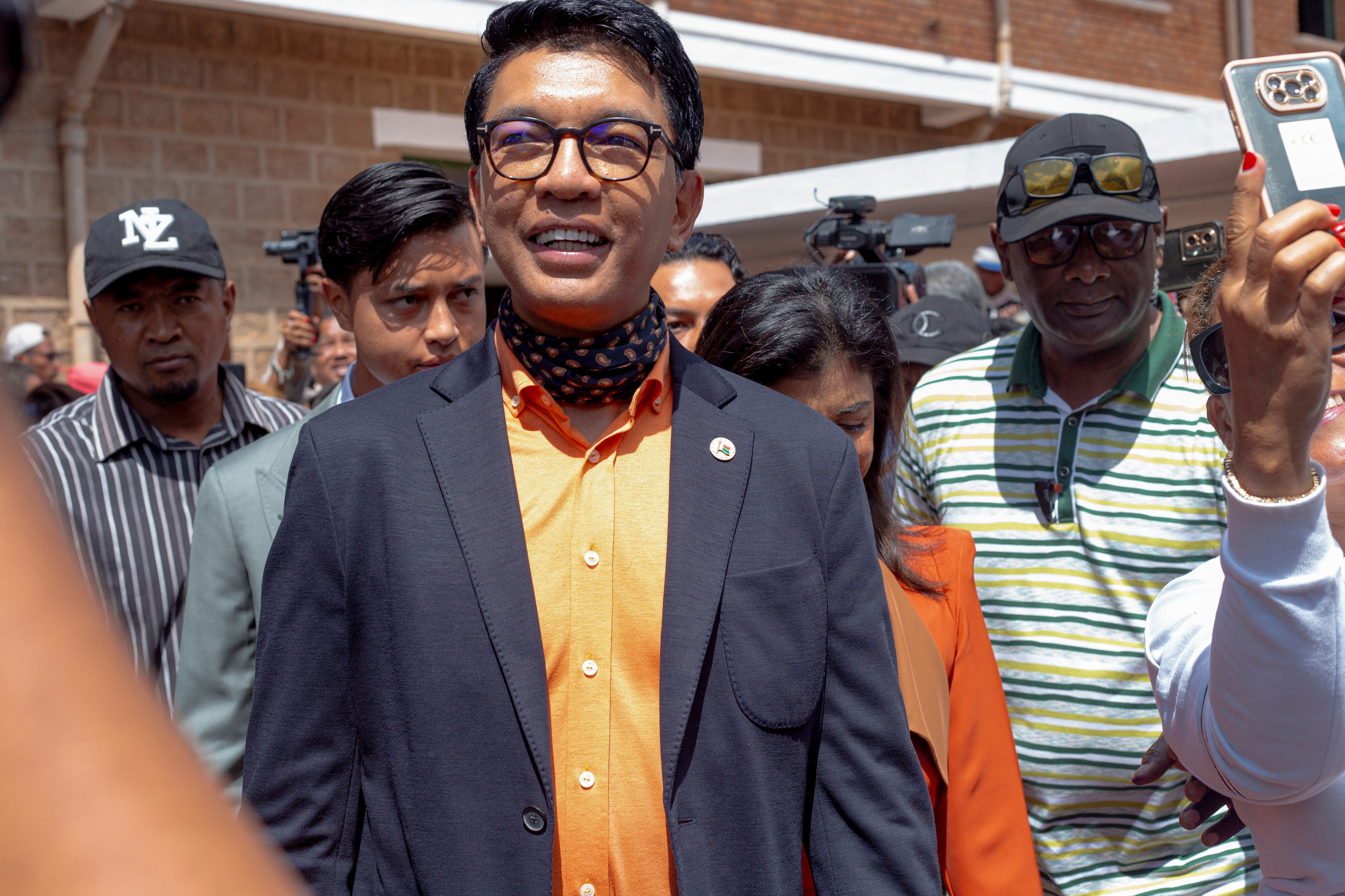 Madagascar's President and a presidential candidate Andry Rajoelina flanked by his wife Mialy Rajoelina as he arrives to cast his ballot at a polling station, during the presidential election in Ambatobe