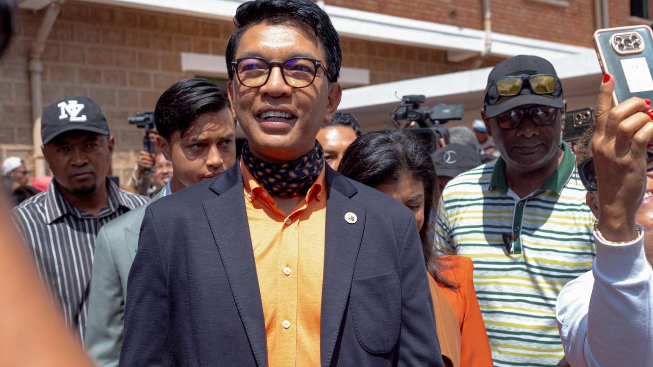 Madagascar's President and a presidential candidate Andry Rajoelina flanked by his wife Mialy Rajoelina as he arrives to cast his ballot at a polling station, during the presidential election in Ambatobe