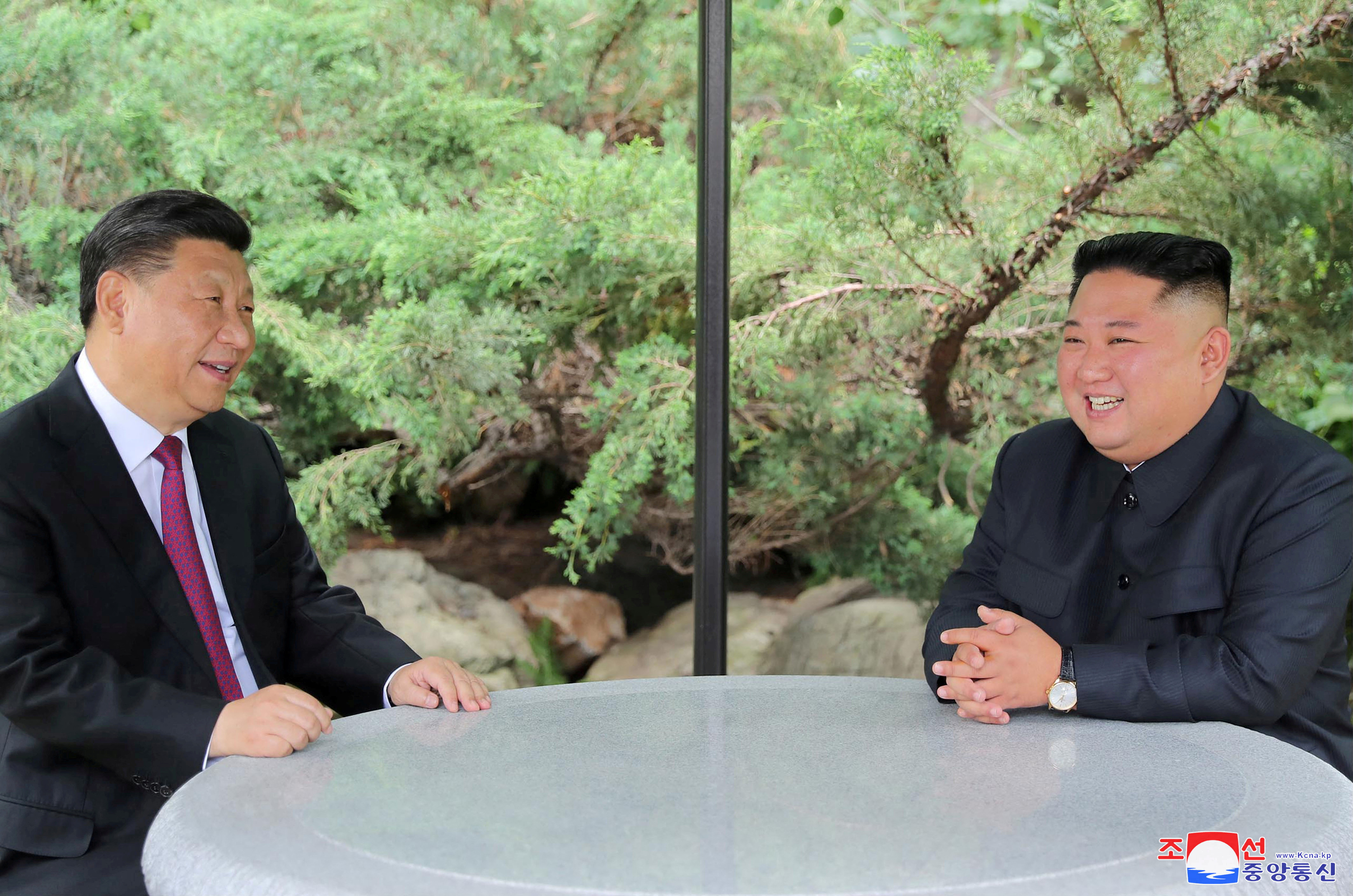 FILE PHOTO: Chinese President Xi Jinping and North Korean leader Kim Jong Un take a walk in Pyongyang