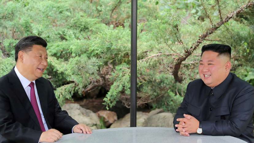 FILE PHOTO: Chinese President Xi Jinping and North Korean leader Kim Jong Un take a walk in Pyongyang