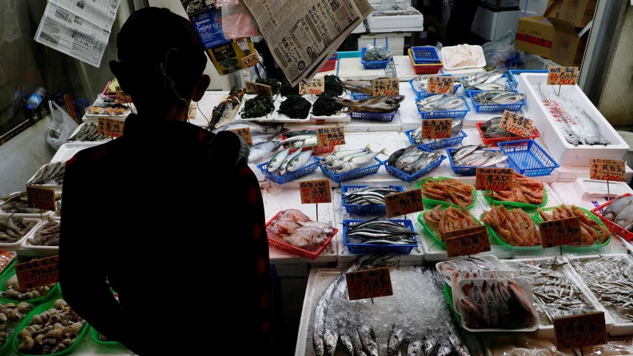 A customer looks around seafood at a shop in Tokyo