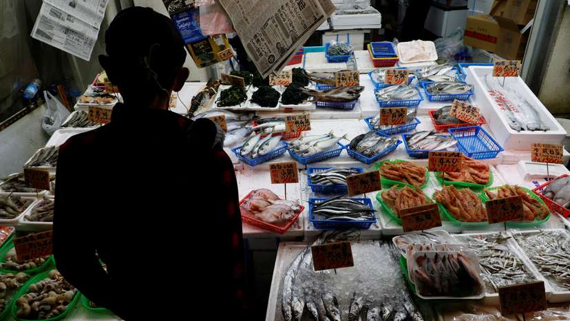 A customer looks around seafood at a shop in Tokyo