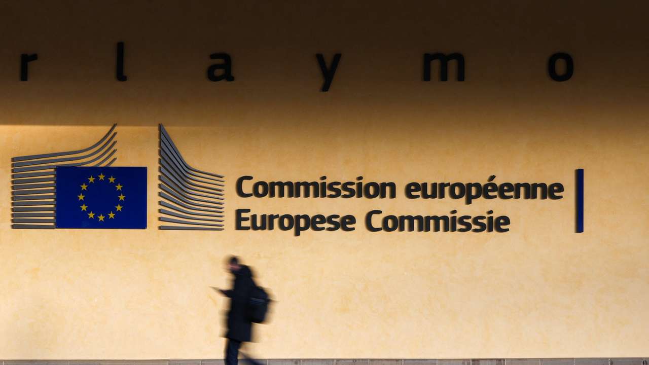 A person walks past the entrance of the European Commission headquarters in Brussels