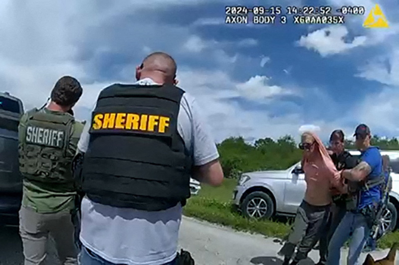 Suspected Trump golf course gunman Ryan W. Routh stands handcuffed after his arrest during a traffic stop near Palm City