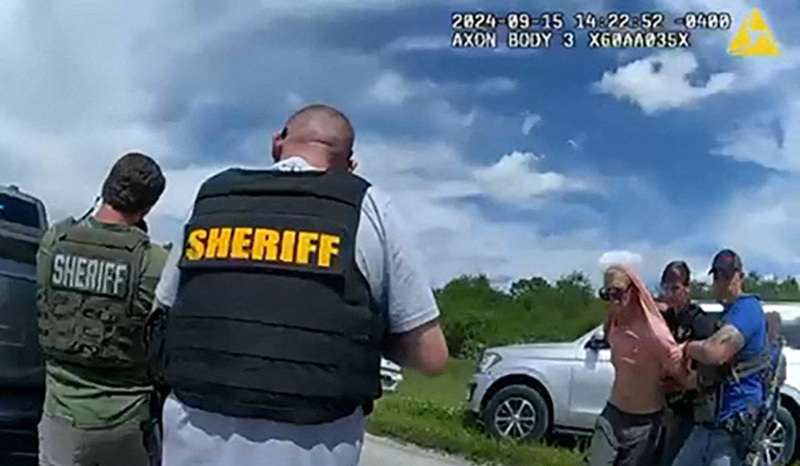Suspected Trump golf course gunman Ryan W. Routh stands handcuffed after his arrest during a traffic stop near Palm City