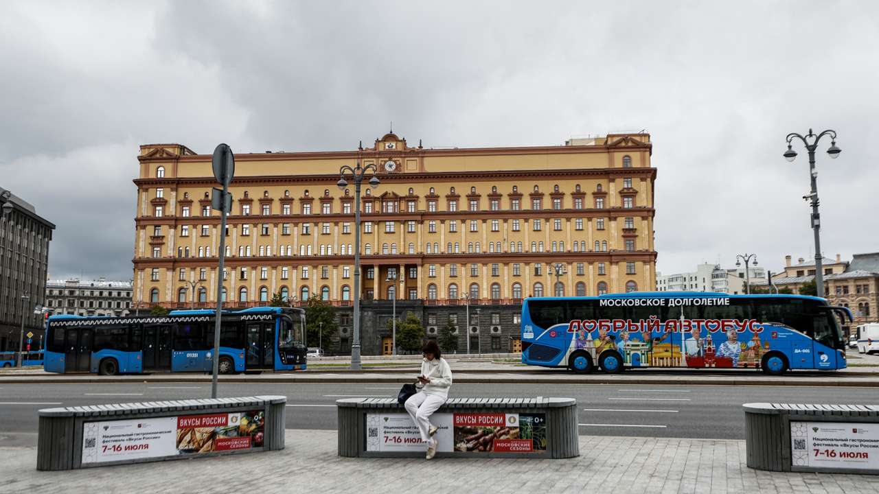 A woman uses her mobile phone in front of the Federal Security Service in Moscow