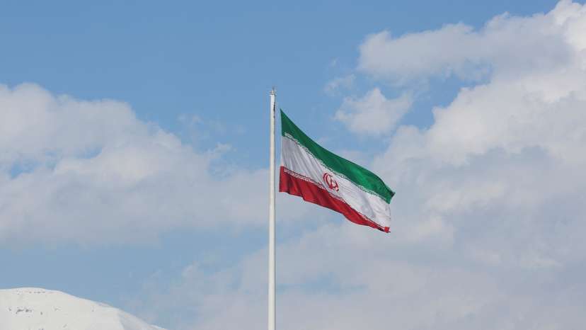 The Iranian flag is seen flying over a street in Tehran