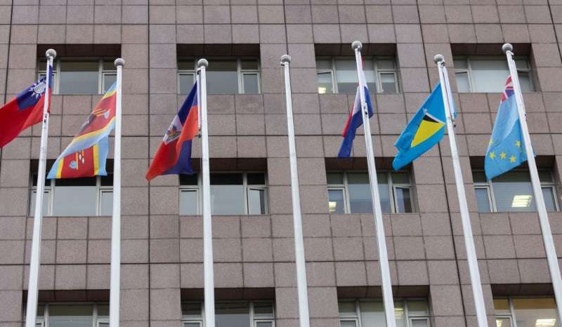 An empty flag pole where Nauru's flag used to fly is pictured next to flags of other countries at the Diplomatic Quarter which houses embassies in Taipei