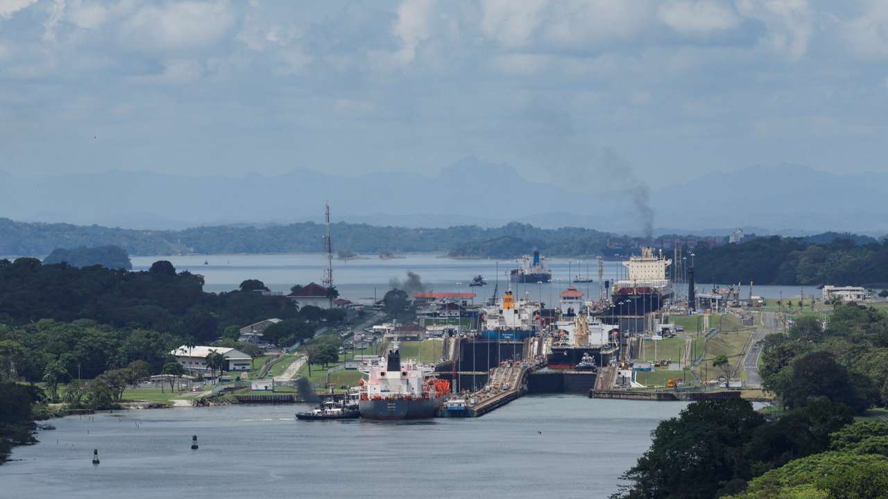 Cargo vessels transit through the Panama Canal, in Colon