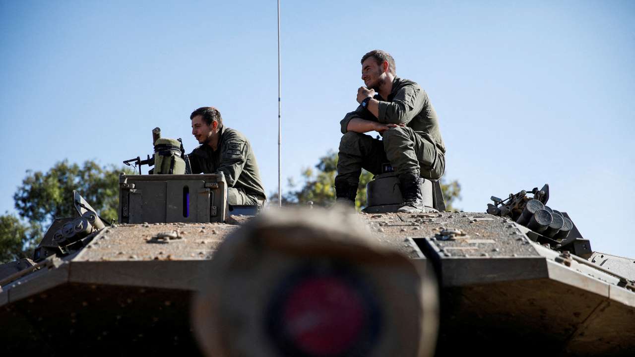 FILE PHOTO: Israeli soldiers sit on a military vehicle near Israel's border with Lebanon