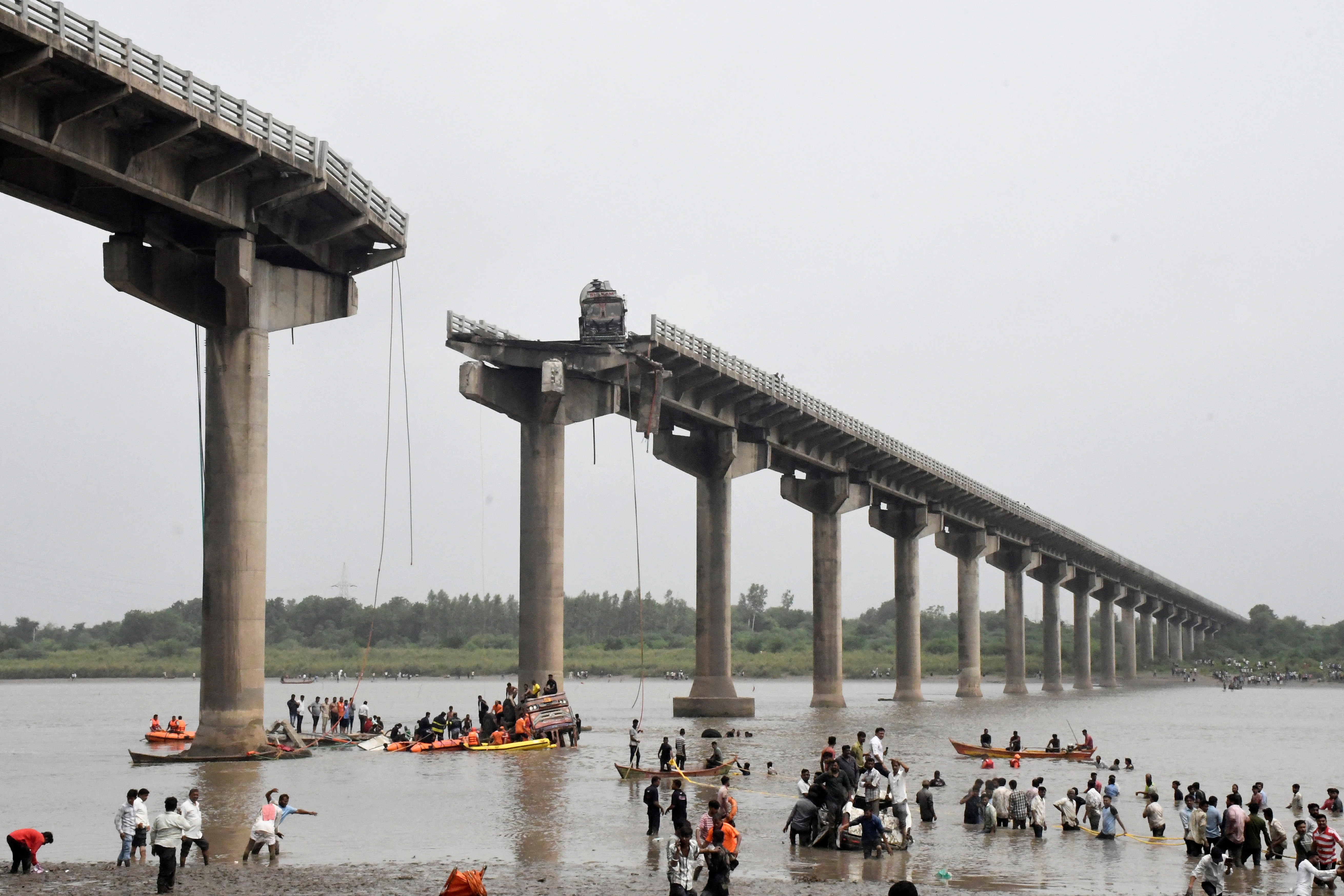 Rescuers search for survivors after a bridge collapsed in Vadodara