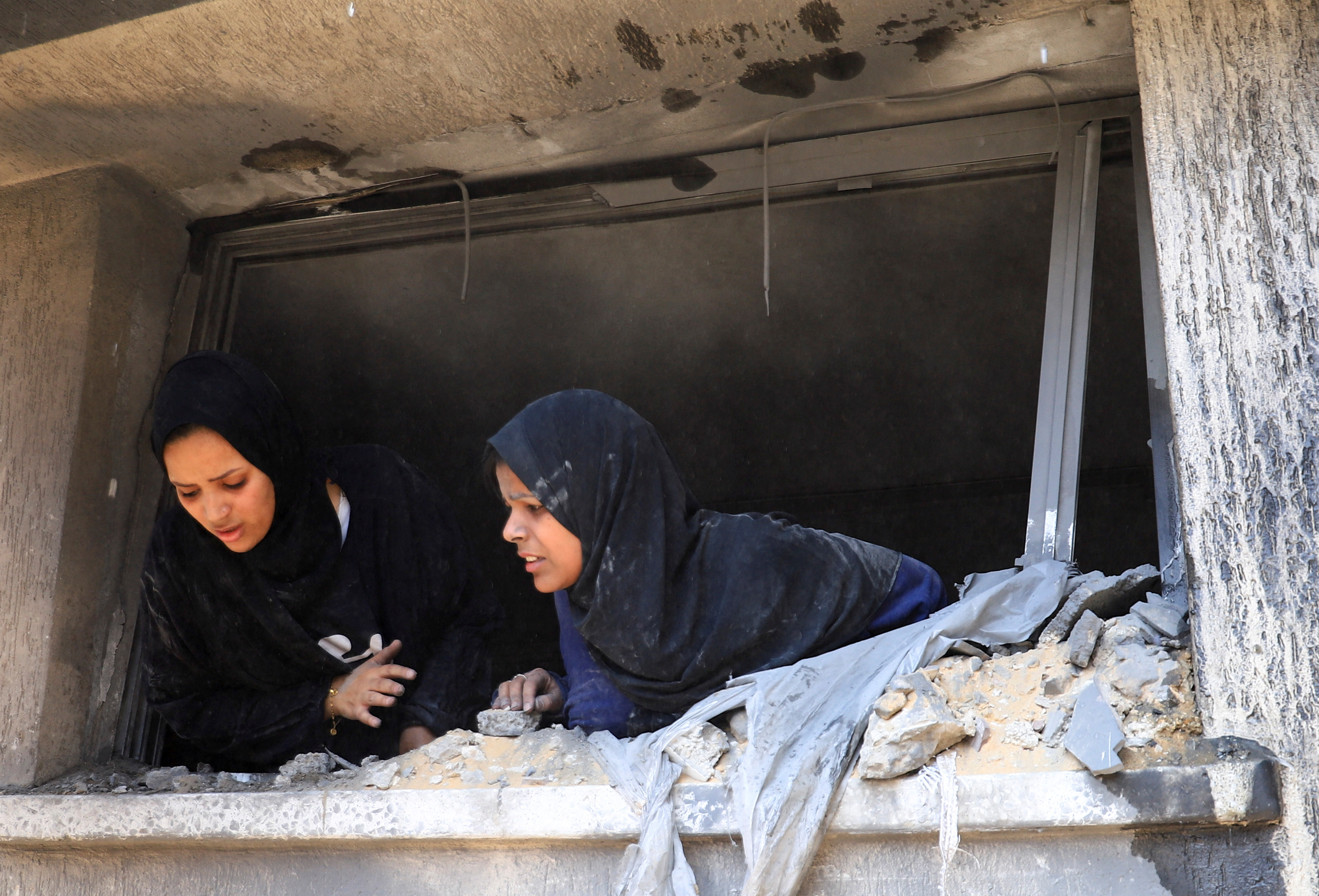 Palestinians search for casualties at the site of an Israeli strike on a house in Gaza City