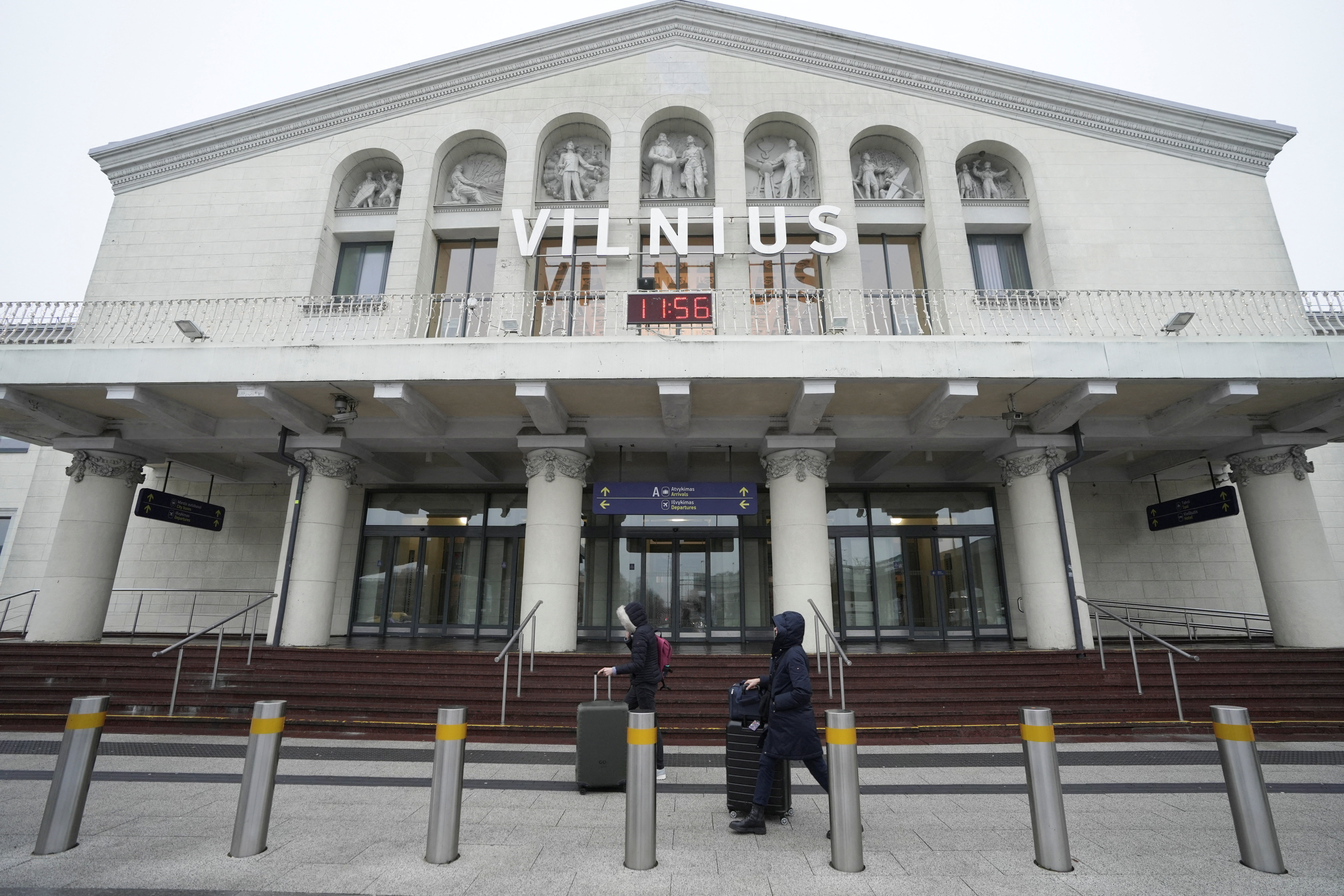 Passengers walk past the arrival terminal in Vilnius Ciurlionis International Airport in Vilnius