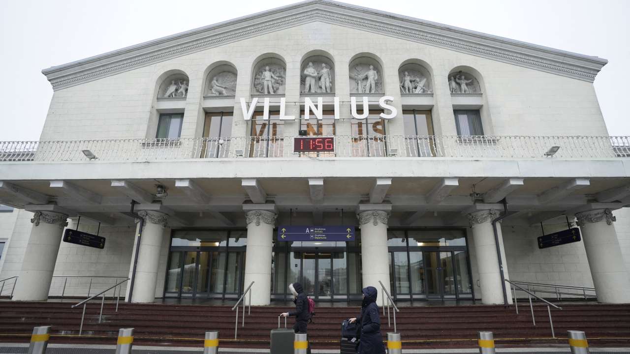 Passengers walk past the arrival terminal in Vilnius Ciurlionis International Airport in Vilnius