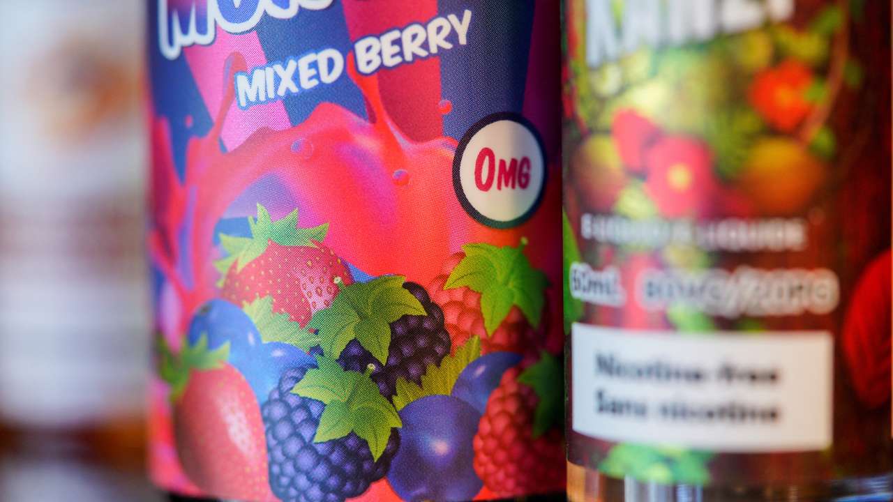 Vaping products stand on a vape store counter